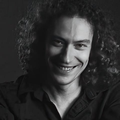 Alexander Seleznyov, smiling, in black and white
